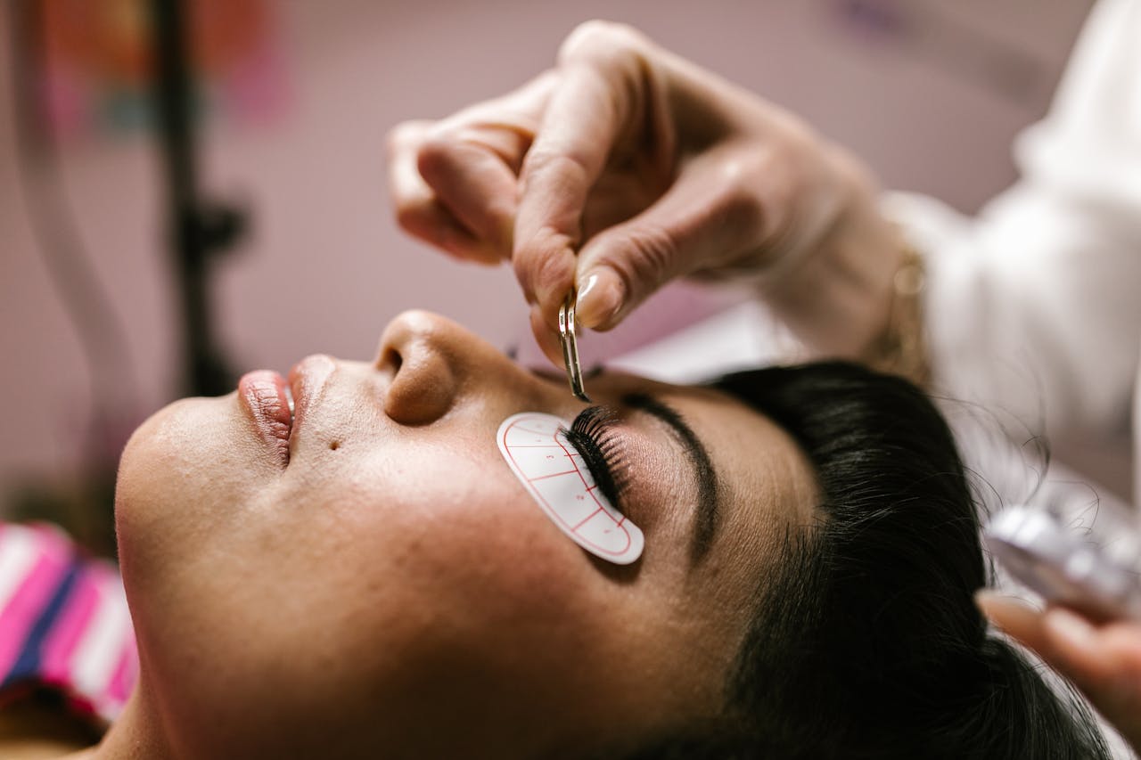 our-story Close-up of a woman receiving eyelash extensions at a beauty salon.